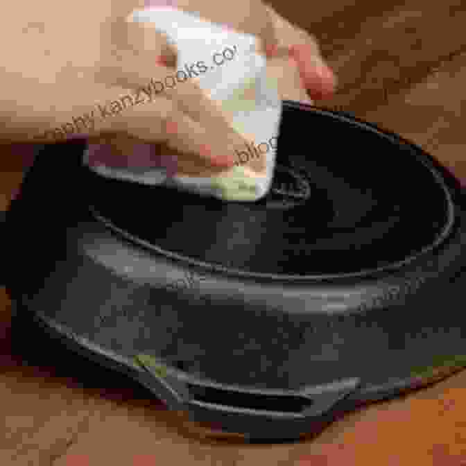 A Person Consulting A Book While Looking At A Cast Iron Pan, Demonstrating Troubleshooting Techniques Cast Iron Cuisine: Essential Tools For Your Iron Cookware: Making Cast Iron Pan Food